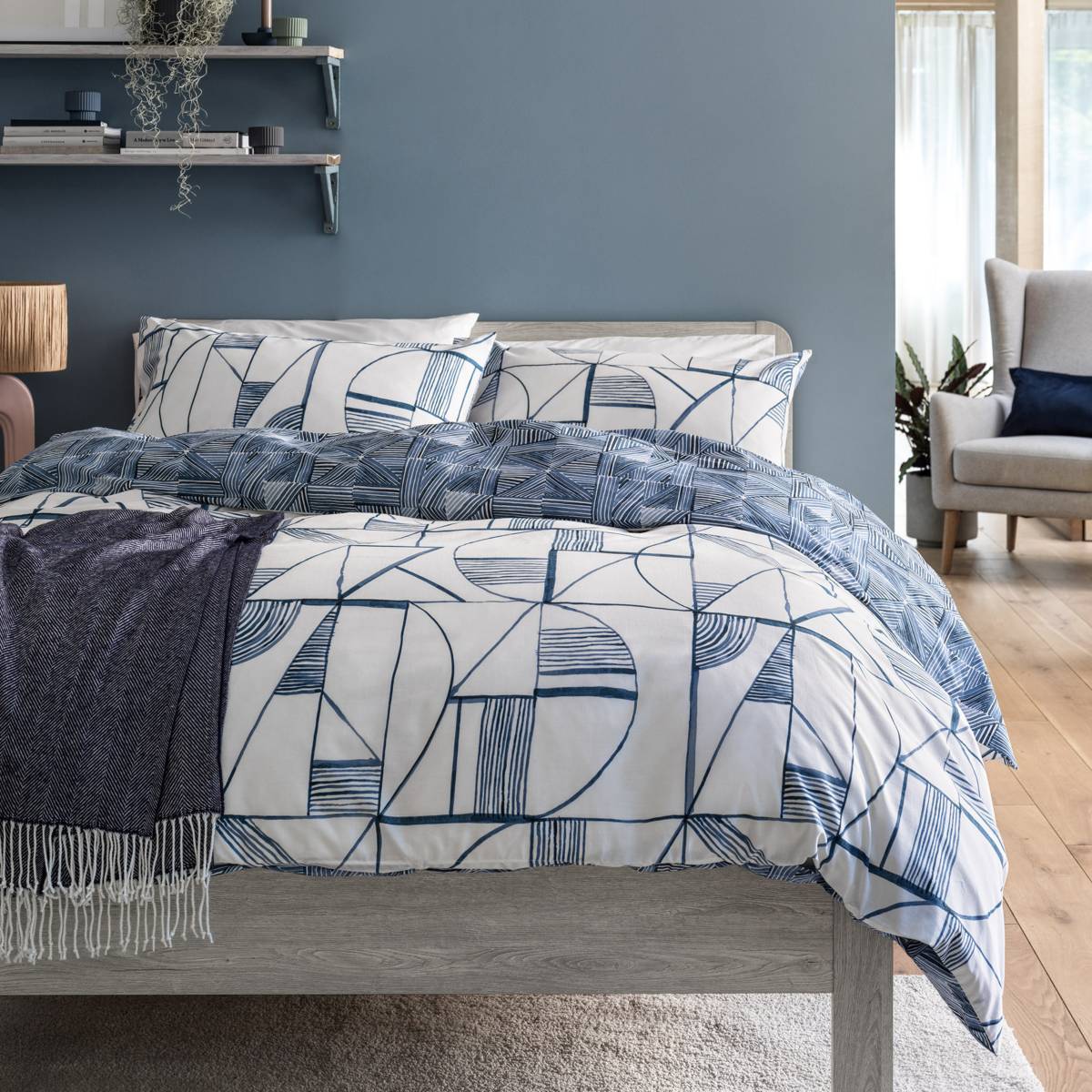 White and blue bedding with geometric pattern. Shop bedding